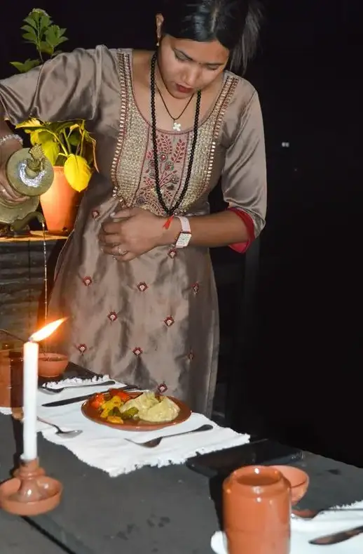 Staff serving newari liquor (aaila) to guest